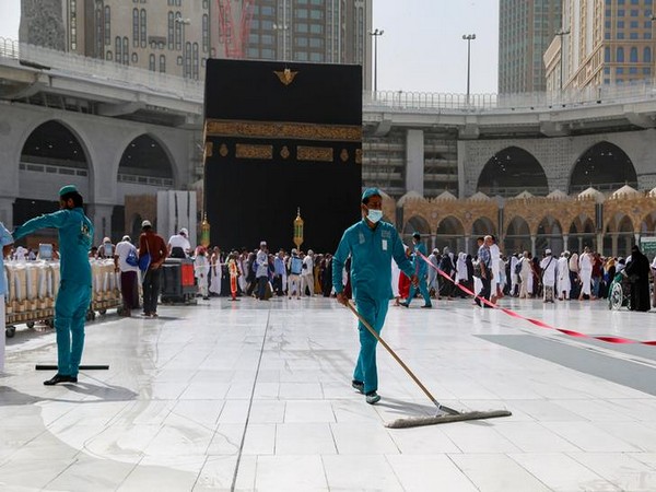 Cleaners wear protective face masks, following the outbreak of the coronavirus, in Mecca