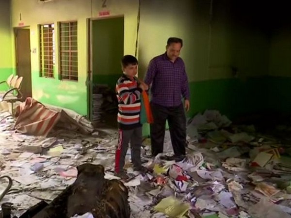A student visits Rajdhani Public Sr Secondary School with his father. Photo/ANI