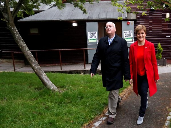 Scotland's First Minister Nicola Sturgeon and her husband Peter Murrell arrive at a polling station during the European Parliament Elections on May 23