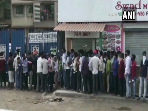 Migrant workers queue outside medical clinics in Dombivli city of Thane.