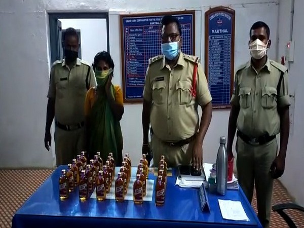 Police with seized liquor bottles, arrested shopkeeper in Makhtal, Telangana on Friday.