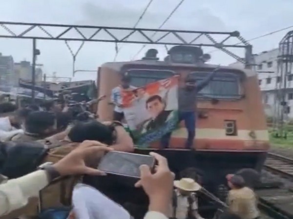 Congress workers trying to stop a train at Mumbai's Borivali railway station in protest against ED