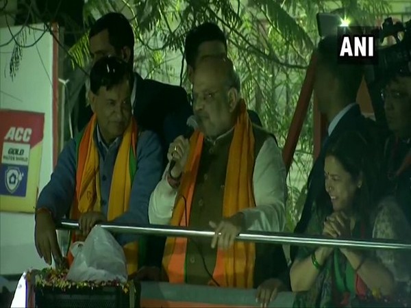 Union Home Minister Amit Shah addressing a gathering during roadshow in Delhi on Tuesday.