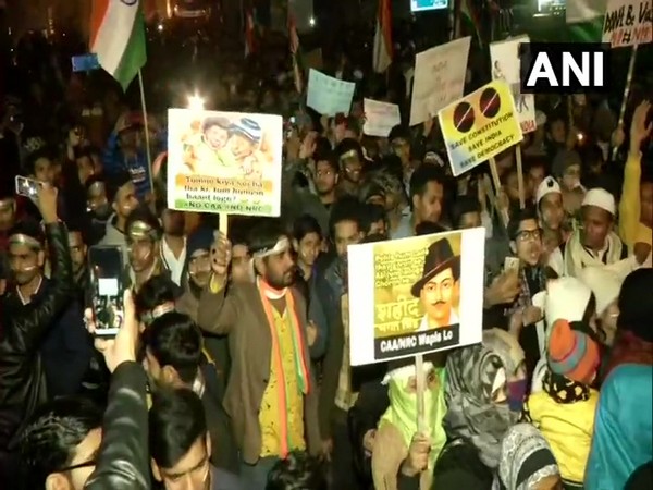 People take out a candle march protest against CAA, NPR and NRC from outside Jamia Millia Islamia to Shaheen Bagh on Sunday. (Photo/ANI)