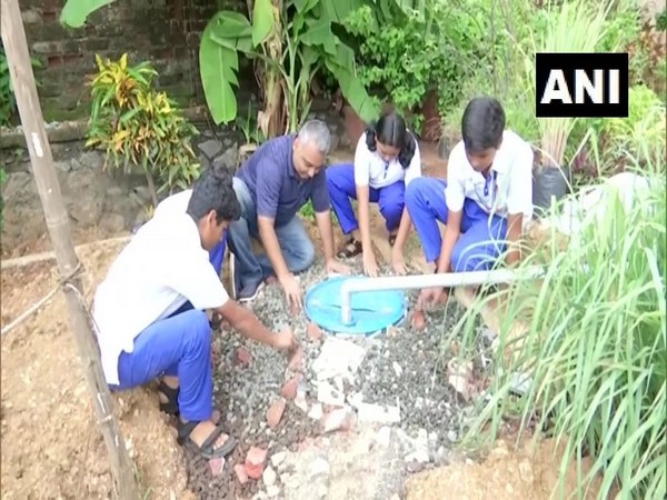 Subhajit Mukherjee installing 'Rainwater Reserve Drums' system with the helpo school students in Mumbai, Maharashtra.