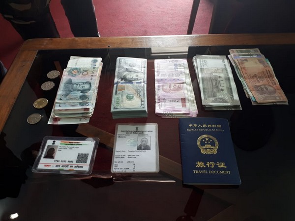 Documents and currency seized by the SSB from the arrested Chinese national.