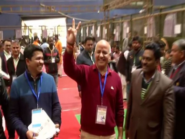 Delhi Deputy CM Manish Sisodia shows victory sign as he leads from Patparganj Assembly seat on Tuesday. Photo/ANI