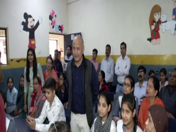 Deputy Chief Minister Manish Sisodia with students of GBSS School at Gokalpur on Wednesday. Photo/ANI