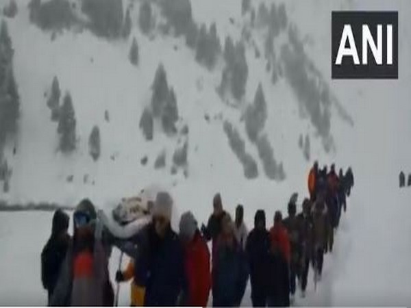 Visual of villagers and police carrying cop in Lahul Spiti. (Photo/ANI)