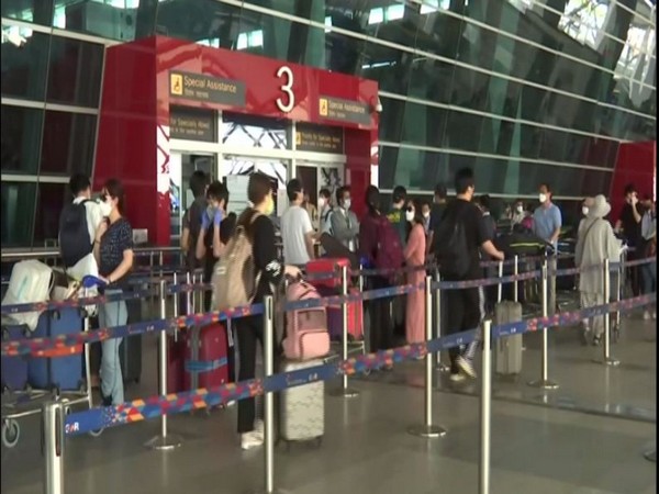 People were seen maintaining social distancing norms while standing in a queue at the airport. Photo/ANI
