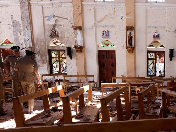 Sri Lankan police investigating the bomb site following the coordinated bomb blasts on Sunday