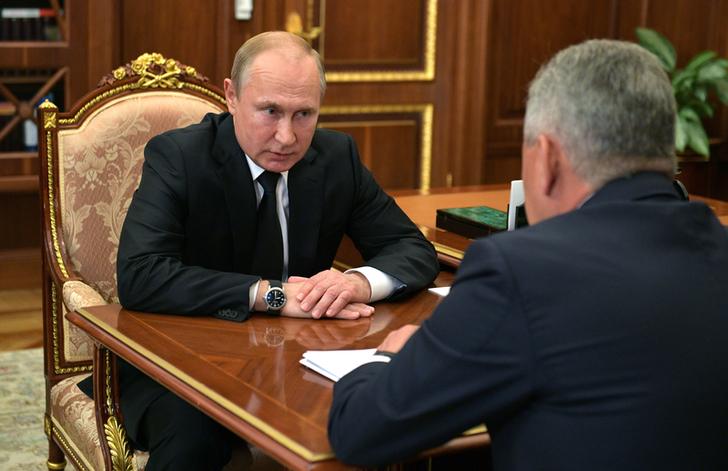 Russian President Vladimir Putin in a meeting with Defense Minister Sergei Shoigu