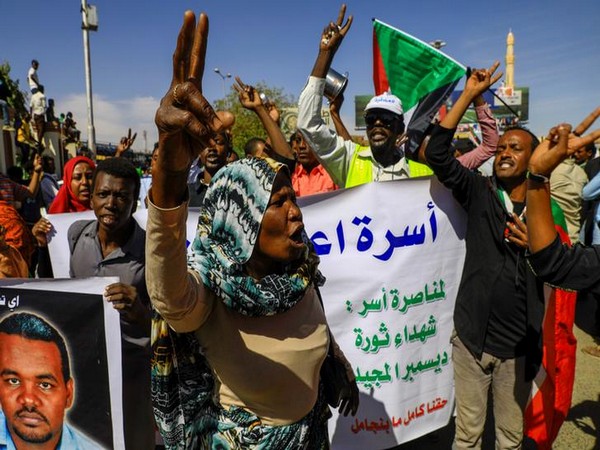 Sudanese civilians celebrate after the sentencing of 29 members of the national intelligence service to death by hanging over the killing of a teacher here on Monday. 