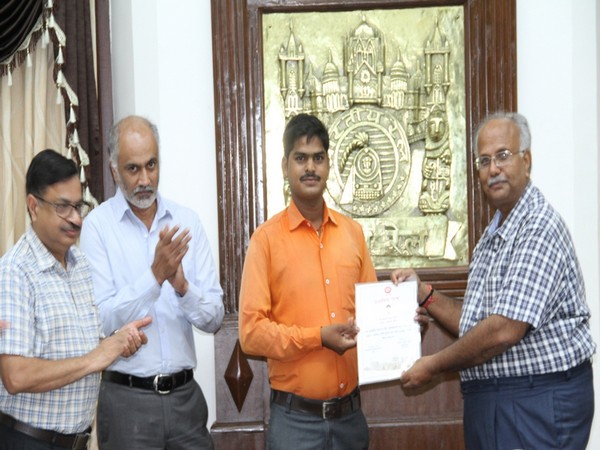 Gateman Sudeshwar Prasad Gupta (in orange shirt) being awarded by Central Railway officials.