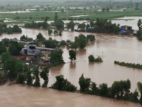 IAF helicopter rescuing people stranded in floods in Surat. Photo/ANI