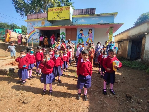 A group of pre-school students at an AWC wearing the distributed shoes, socks and sweater. Photo/ANI
