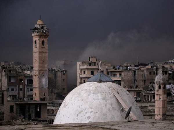Smoke rises near a damaged mosque in Maarat al-Numan, Syria.