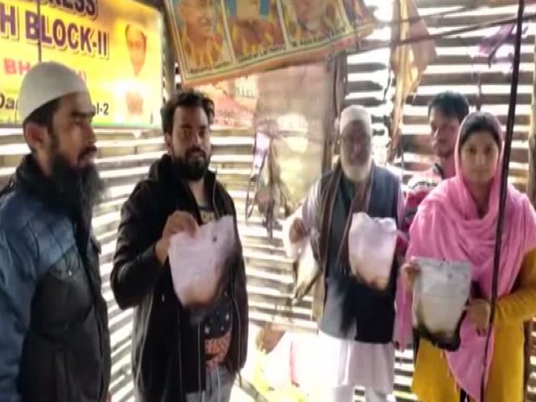 TMC workers and Councillor Mohammad Hamid Ansari showing the damage done by the fire at the TMC office in Asansol on Saturday. Photo/ANI