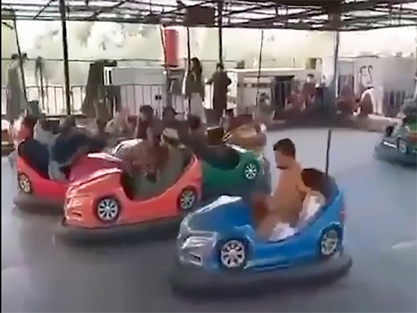 Taliban riding bumper cars at an amusement park in Herat. (Photo credit: NYT)