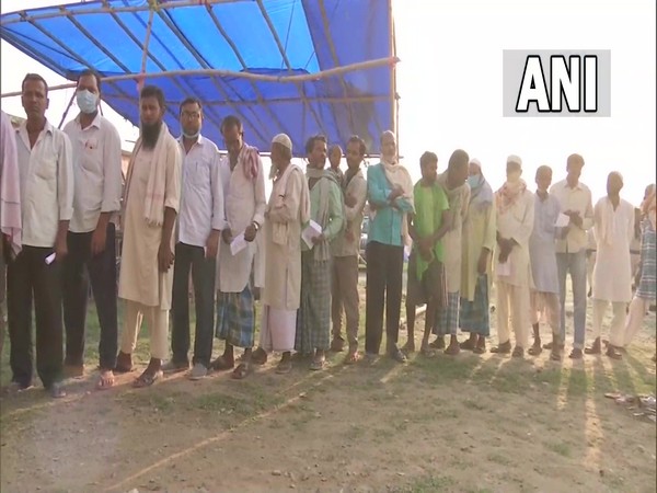 Voter queue up to cast their vote for by-poll to Kusheshwar Asthan assembly seat in Bihar's Darbhanga on Saturday. (Photo/ ANI)