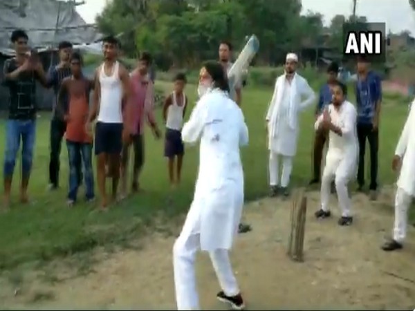 RJD leader Tej Pratap Yadav playing cricket with children in Hasanpur constituency on Sunday.
