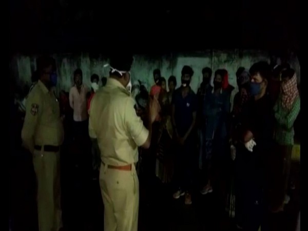 Officials from Telangana Police talking to migrant workers. Photo/ANI