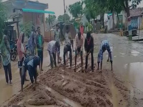 Villagers sowed paddy on damaged road as a sign of protest in Siddipet district, Telangana on Sunday. (Photo/ANI)
