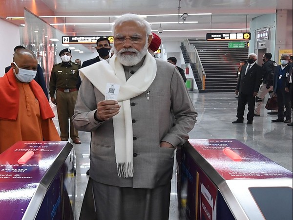 Prime Minister Narendra Modi purchases tickets of Kanpur Metro for taking ride. 