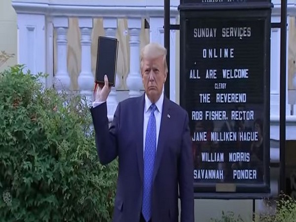 US President Donald Trump poses for photos outside St John's church on Monday