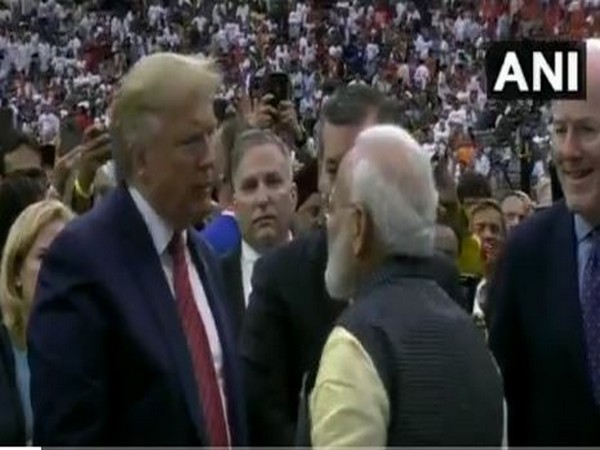 Prime Minister Narendra Modi and US President Donald Trump conversing amid a loud cheering crowd in Houston on Sunday