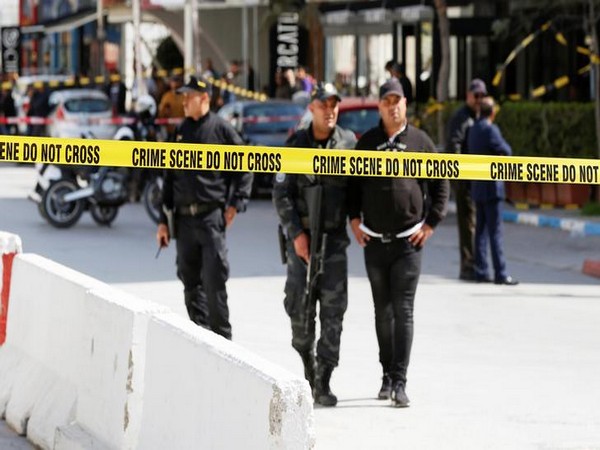 Police officers stand guard at the site of a suicide attack near the U.S. embassy in Tunis