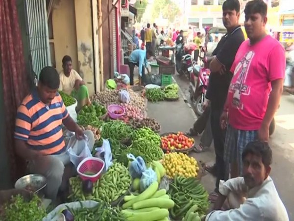 People buying vegetables in a local market in Varanasi in Uttar Pradesh on Tuesday. Photo/ANI
