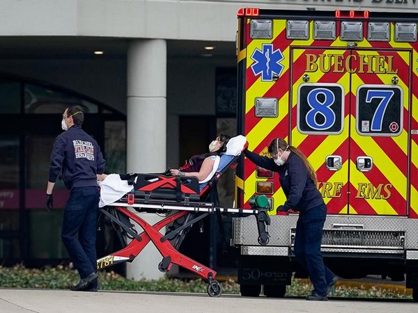    Emergency medical personnel transporting a patient suffering from COVID-19 into the emergency department in Louisville, Kentucky, US, March 24.