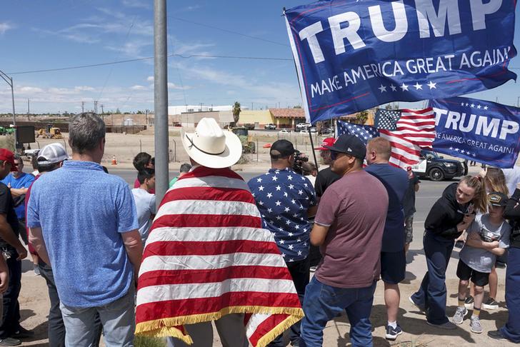 Supporters of US President Donald Trump stand near the border during a rally as Trump visits the U.S.-Mexico border in Calexico, California