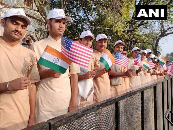 Students holding India and US flags to welcome US President Donald Trump in Gujarat. Photo/ANI