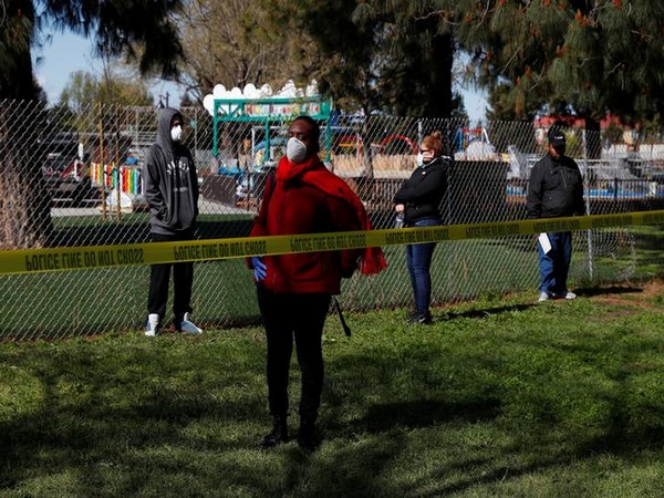 People with symptoms of coronavirus maintain social distance while waiting in line to be tested at the Hayward Fire Department