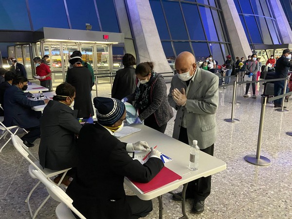 Indian nationals queue at Dulles International Airport in Washington to board a special Air India flight on early Wednesday morning