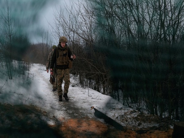 Service members of the Ukrainian armed forces walk at combat positions. (Photo Credit - Reuters)