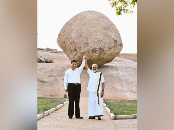 Chinese President Xi Jinping and Prime Minister Narendra Modi holding hands while posing for a picture at Krishna's Butter Ball during the second informal summit in Mamallapuram on Friday.