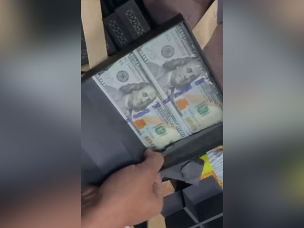 Dollar hidden in false bottom of sweet boxes. (ANI/photo)