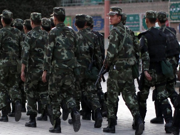 Armed police officers patrol an ethnice Uyghur area in Kashgar, in Xinjiang province. (Photo Credit - Reuters)