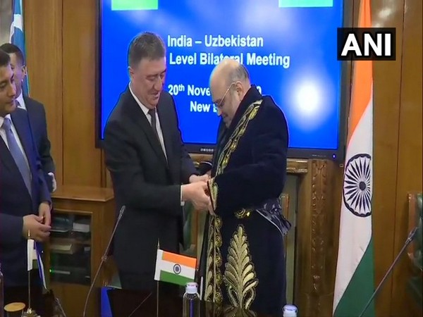 Uzbek minister Pulat Bobojonov felicitates Home Minister Amit Shah
