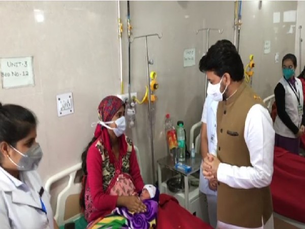 Union Minister Anurag Thakur meeting a patient. (Photos/ANI)