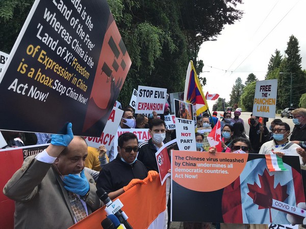 Protestors gather outside the Chinese consulate in Vancouver on Saturday.