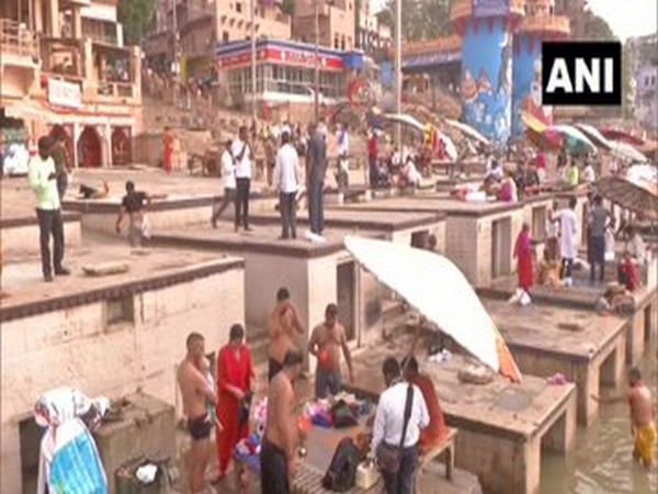Scores of devotees taking a holy dip in river Ganga on the first Monday of Sawan month in Varanasi.