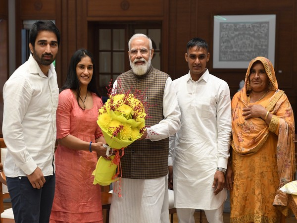 Olympian Vinesh Phogat, family meet PM Narendra Modi (photo/ANI)
