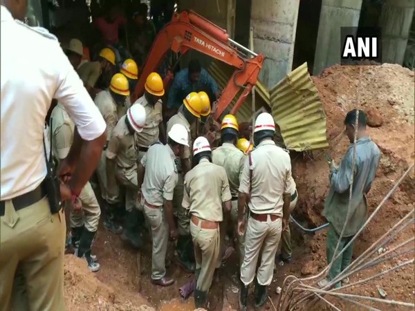 Fire officials conducting rescue work after a compound wall collapsed near a construction site in Mangaluru on Friday.