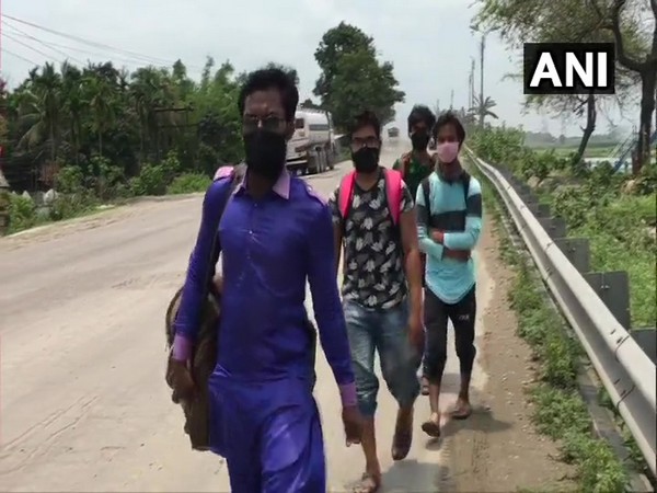 Migrant workers walking to their native places in West Bengal on Monday. [Photo/ANI]