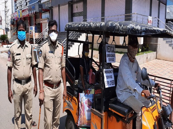Police officers making arrangements of free auto service for needy people during full day curfew in West Godavari district. (Photo/ANI) 