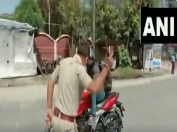 Police beats up a person found to be roaming in the streets without any credible reason